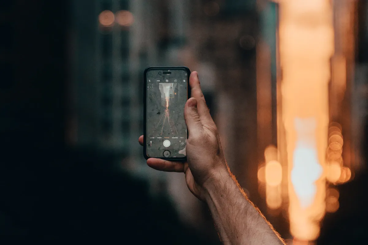 High-resolution photo of an adult holding a smartphone accompanying the secure login guide